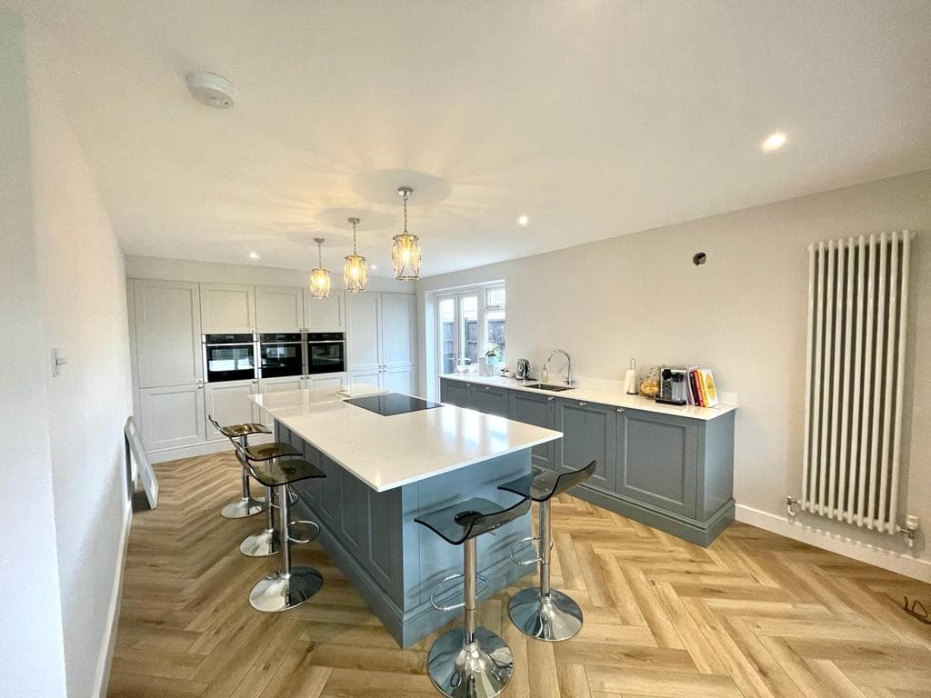 Grey shaker kitchen extension with island, pendant lighting and herringbone oak floor, built by FR Carpentry in Dorset